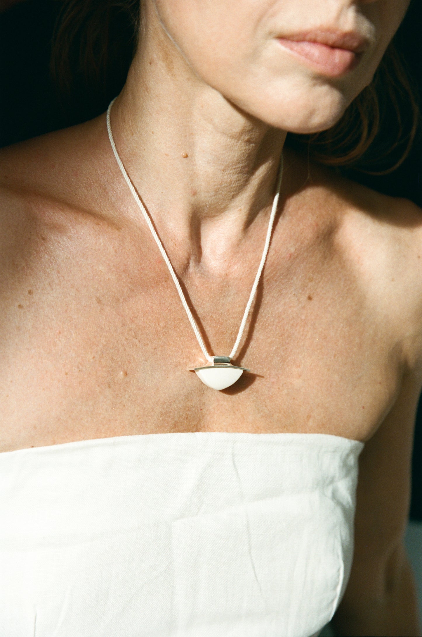RIVERLAKE spade pendant crafted from antler, showcasing intricate details and a unique design against a neutral background.