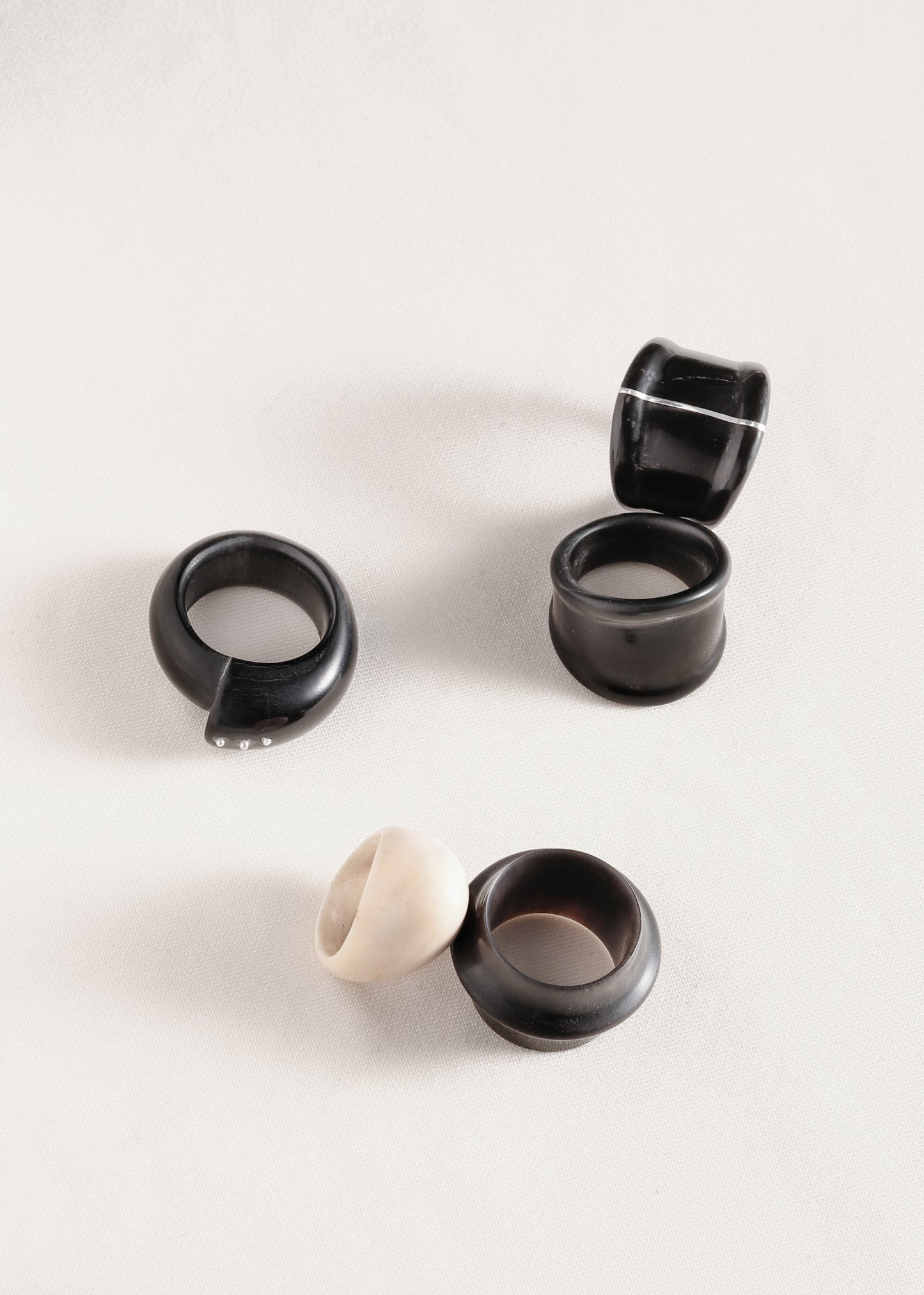 Black buffalo horn curl ring with silver rivets by RIVERLAKE, showcasing an elegant and unique design.