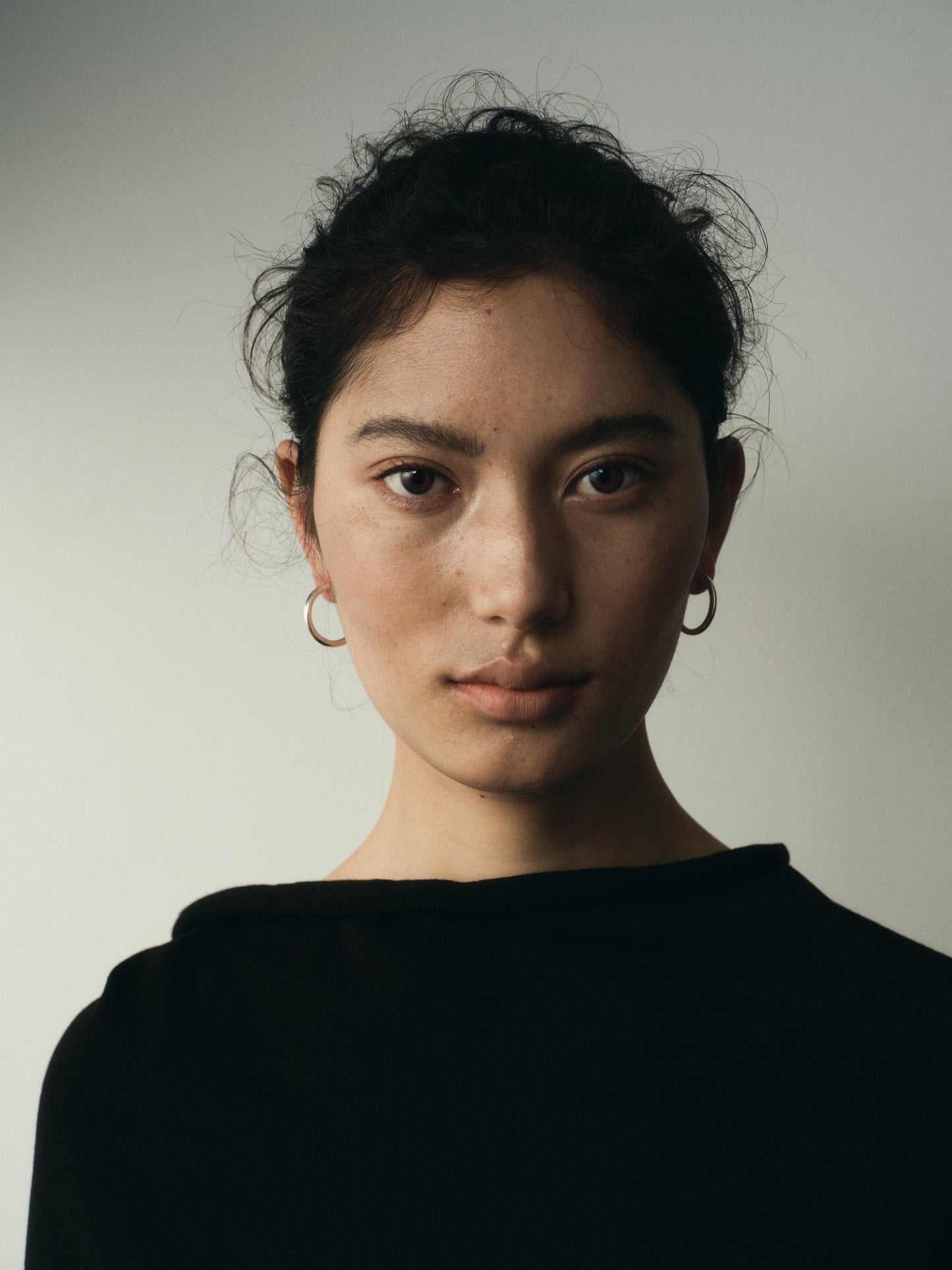 Small yellow buffalo horn hoops by RIVERLAKE, showcasing a unique, lightweight design with a natural finish.