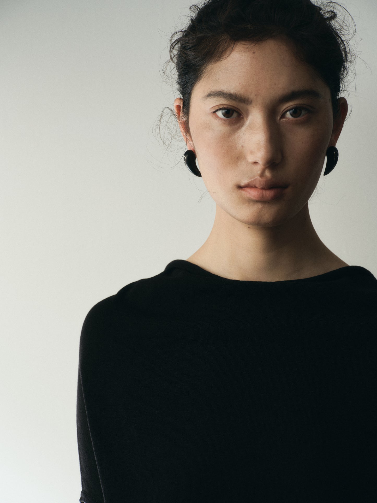 Medium Fang Earrings by RIVERLAKE crafted from black buffalo horn with intricate silver inlay detail.