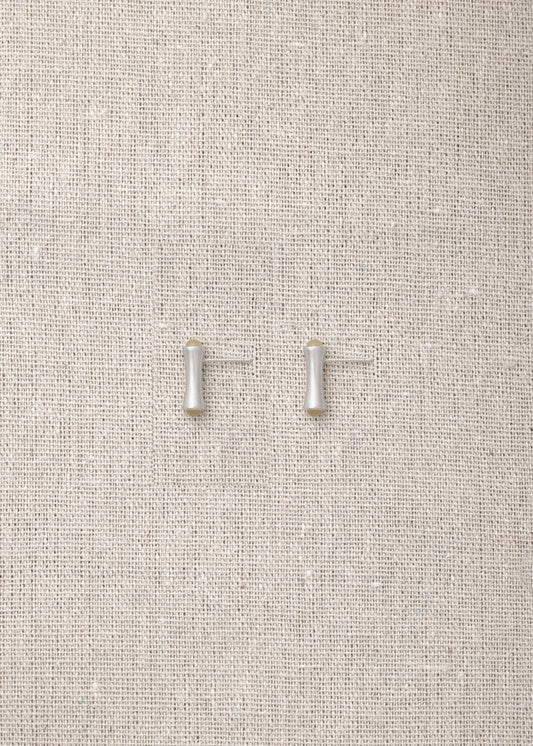 Cove Studs made from natural sheep horn by RIVERLAKE, showcasing a unique, organic design perfect for any outfit.