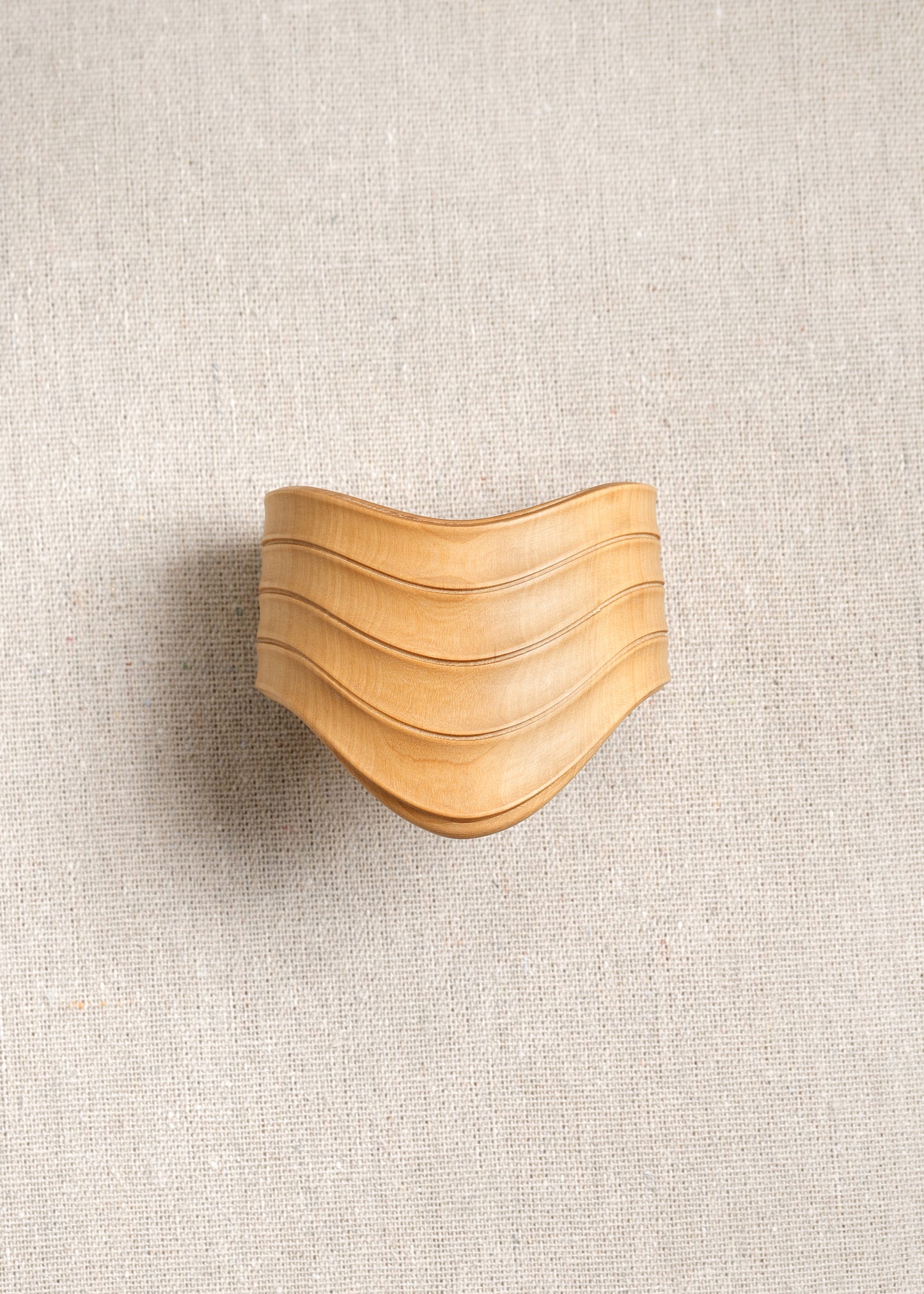 RIVERLAKE Drape Cuff in Boxwood showcasing a textured green fabric with elegant draping detail.