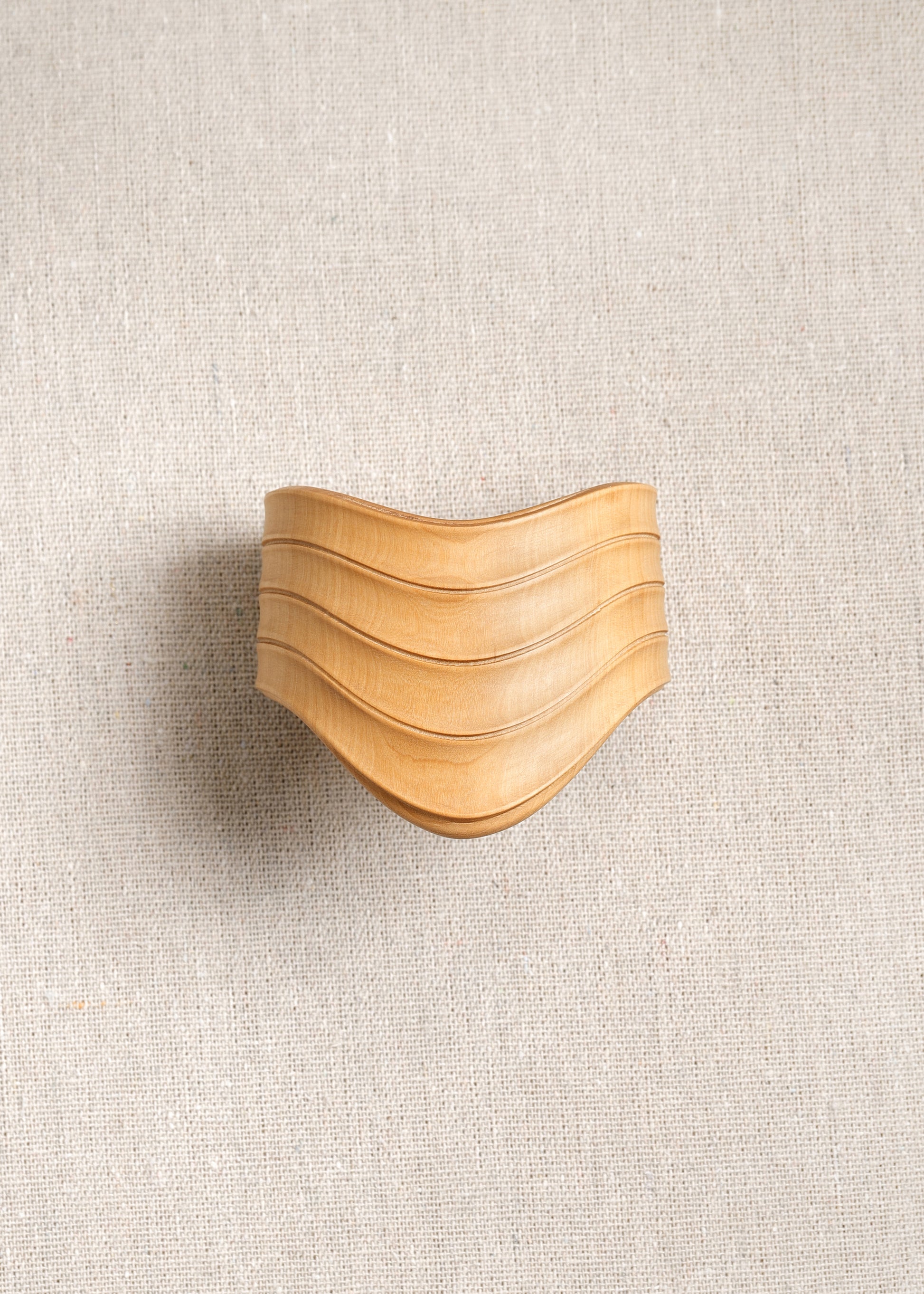 RIVERLAKE Drape Cuff in Boxwood showcasing a textured green fabric with elegant draping detail.