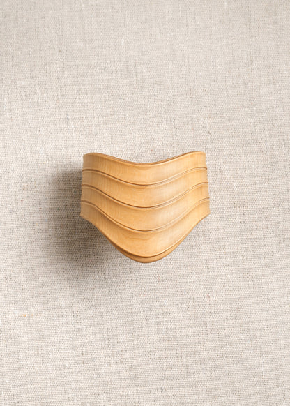 RIVERLAKE Drape Cuff in Boxwood showcasing a textured green fabric with elegant draping detail.