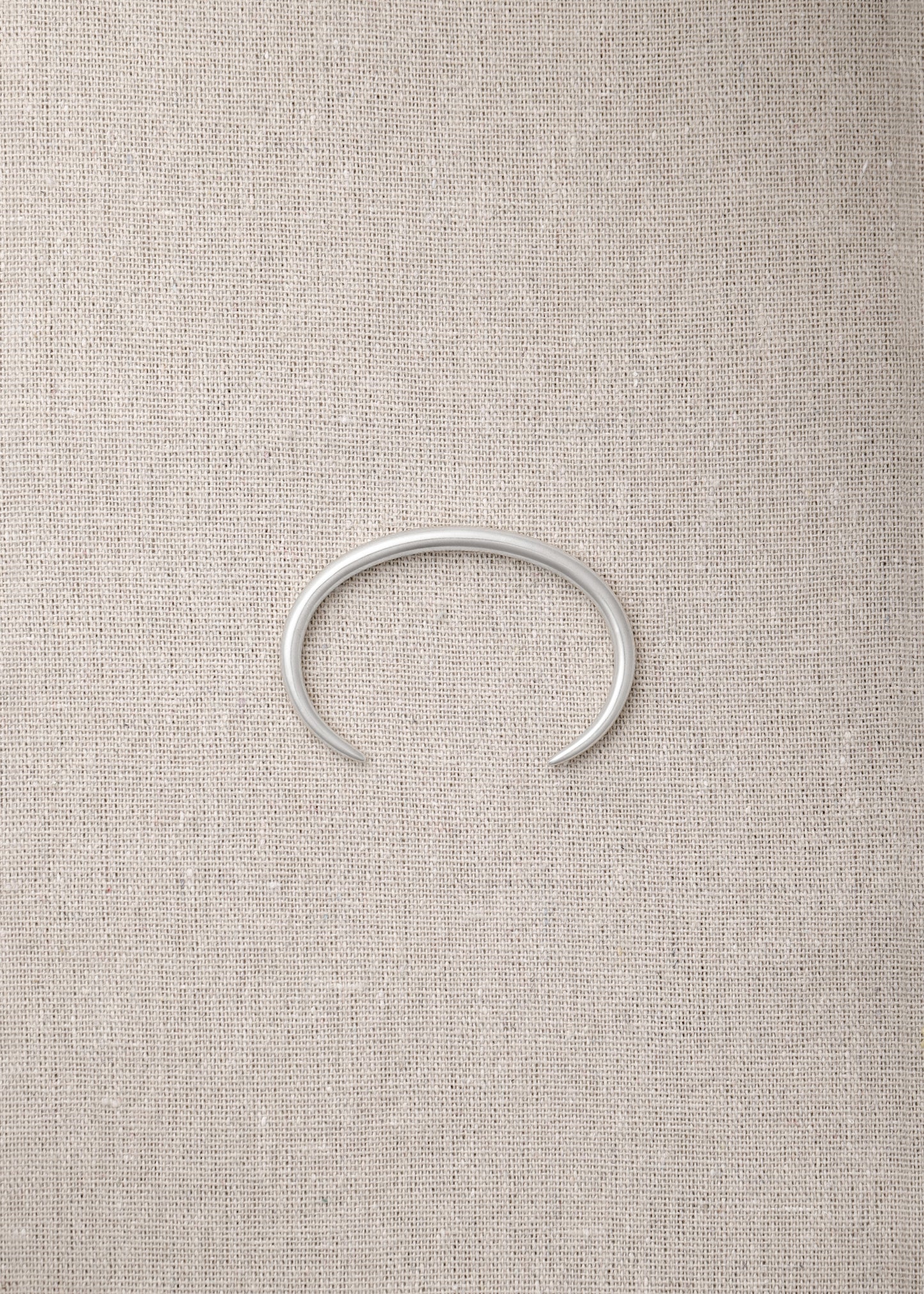 RIVERLAKE Gleam Wrist Cuff featuring a sleek design with a shimmering finish and adjustable strap.