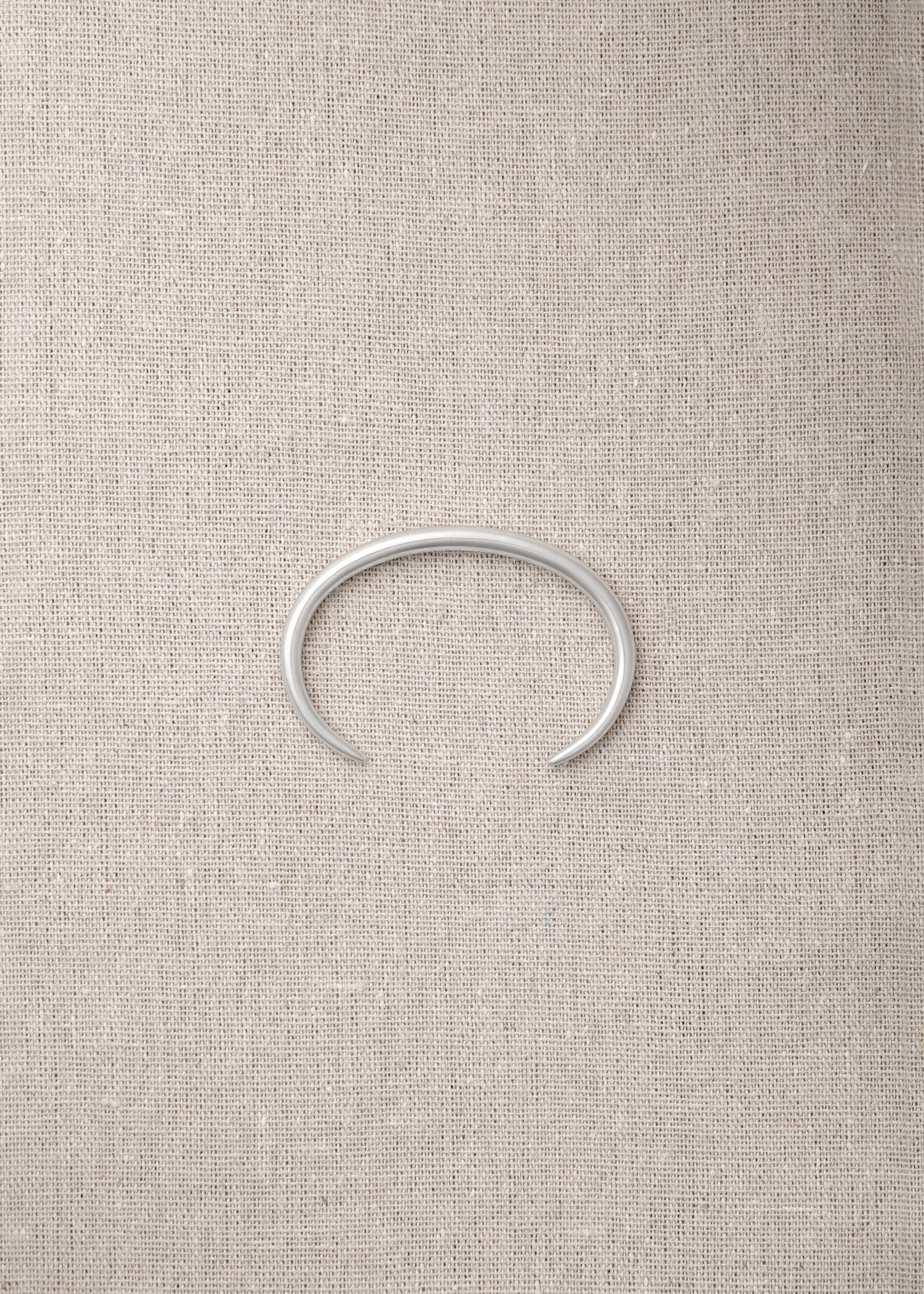 RIVERLAKE Gleam Wrist Cuff featuring a sleek design with a shimmering finish and adjustable strap.