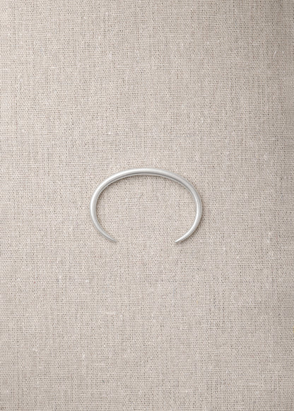 RIVERLAKE Gleam Wrist Cuff featuring a sleek design with a shimmering finish and adjustable strap.