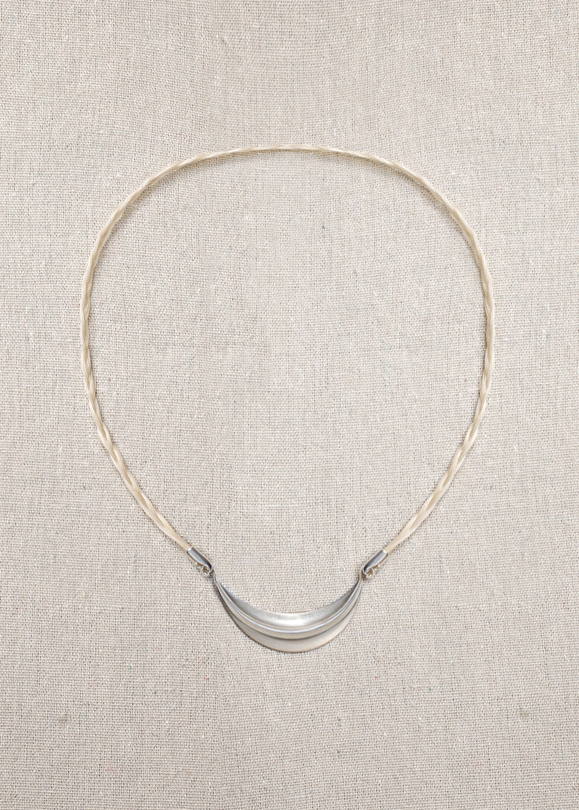 Delicate RIVERLAKE crescent necklace with a polished finish and adjustable chain, elegantly displayed on a soft background.
