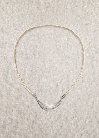 Delicate RIVERLAKE crescent necklace with a polished finish and adjustable chain, elegantly displayed on a soft background.