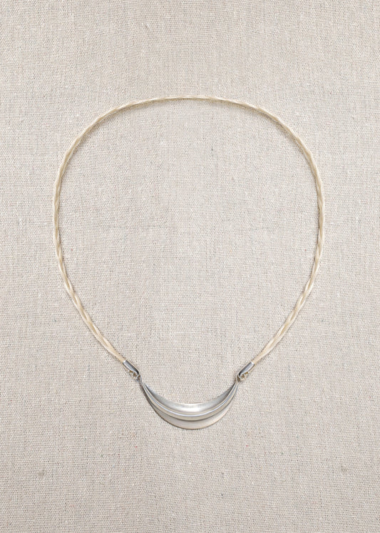Delicate RIVERLAKE crescent necklace with a polished finish and adjustable chain, elegantly displayed on a soft background.