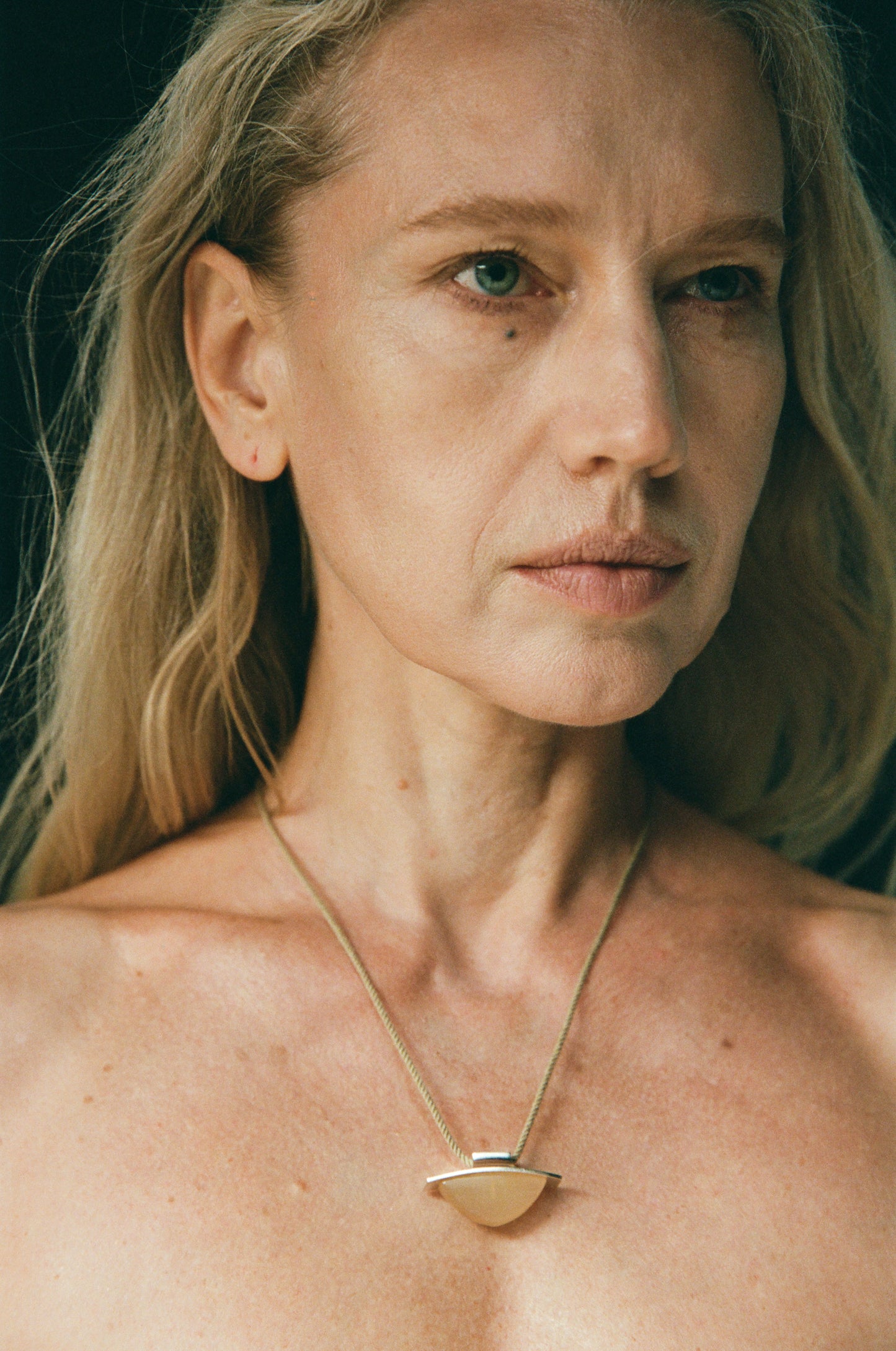 RIVERLAKE spade pendant crafted from natural sheep horn, showcasing unique textures and organic shapes.