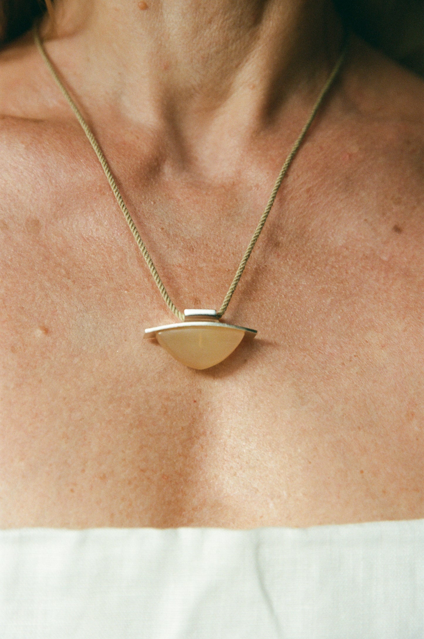 RIVERLAKE spade pendant crafted from sheep horn, showcasing a unique design and natural texture.