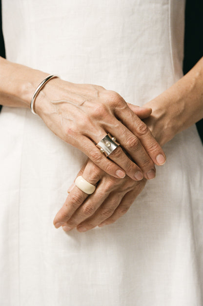 RIVERLAKE Pupil Ring made of yellow buffalo horn, showcasing a smooth, curved design and natural color variations.