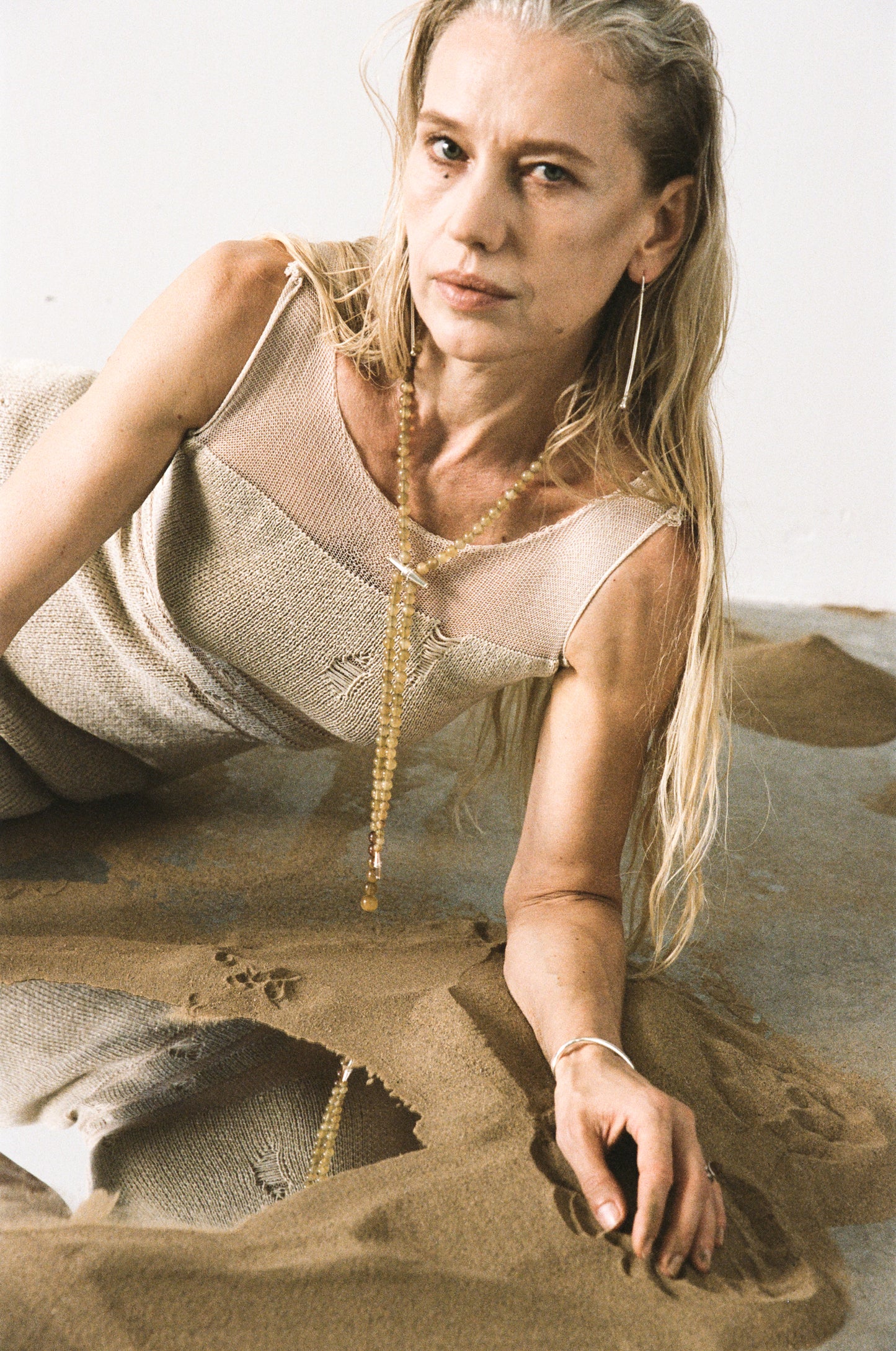 RIVERLAKE fall necklace crafted from sheep horn with natural hues and elegant design hanging on a wooden background.