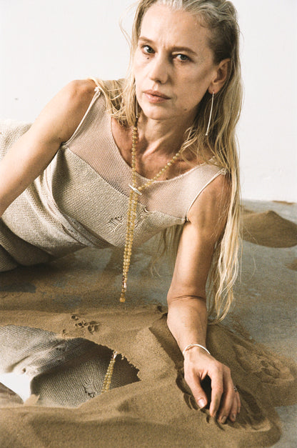 RIVERLAKE fall necklace crafted from sheep horn with natural hues and elegant design hanging on a wooden background.