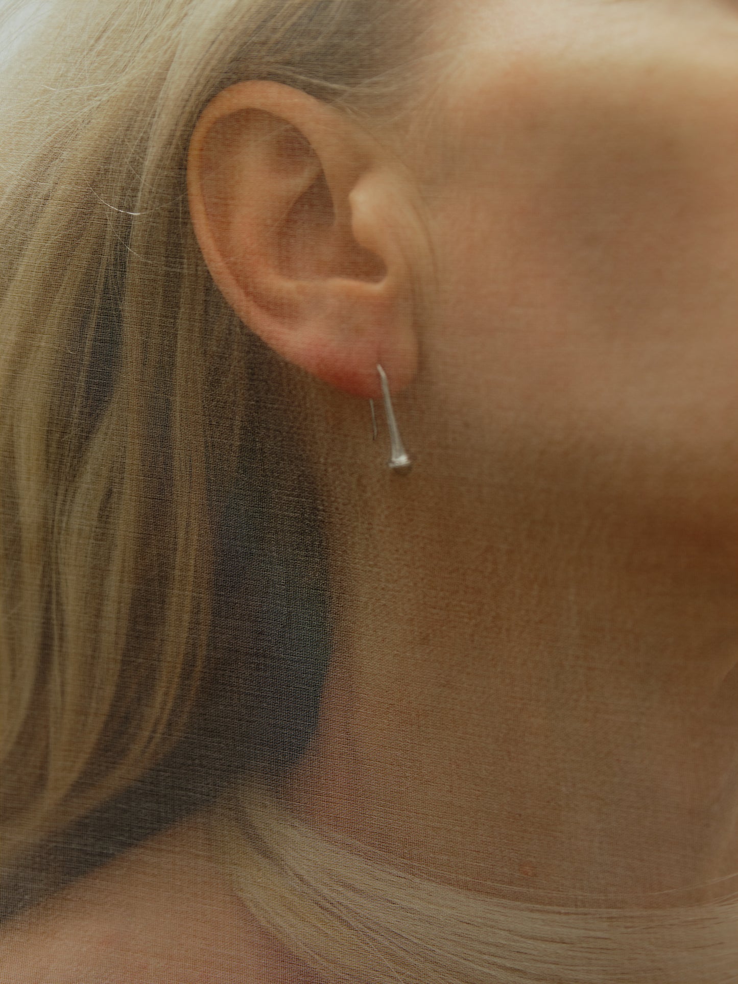Lilt Earrings made of sheep horn by RIVERLAKE, showcasing unique natural patterns and an elegant design.
