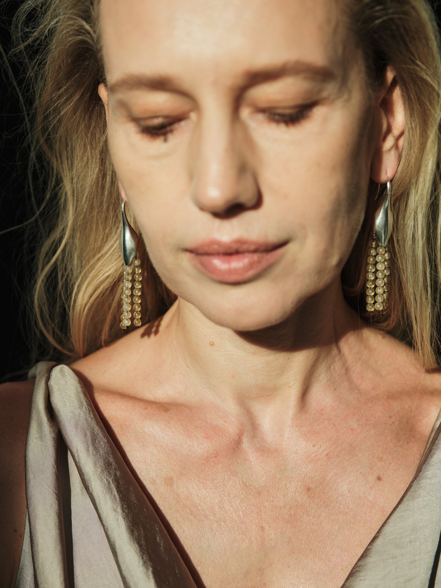 Petal earrings made from sheep horn by RIVERLAKE, showcasing a unique, organic shape and natural color variations.