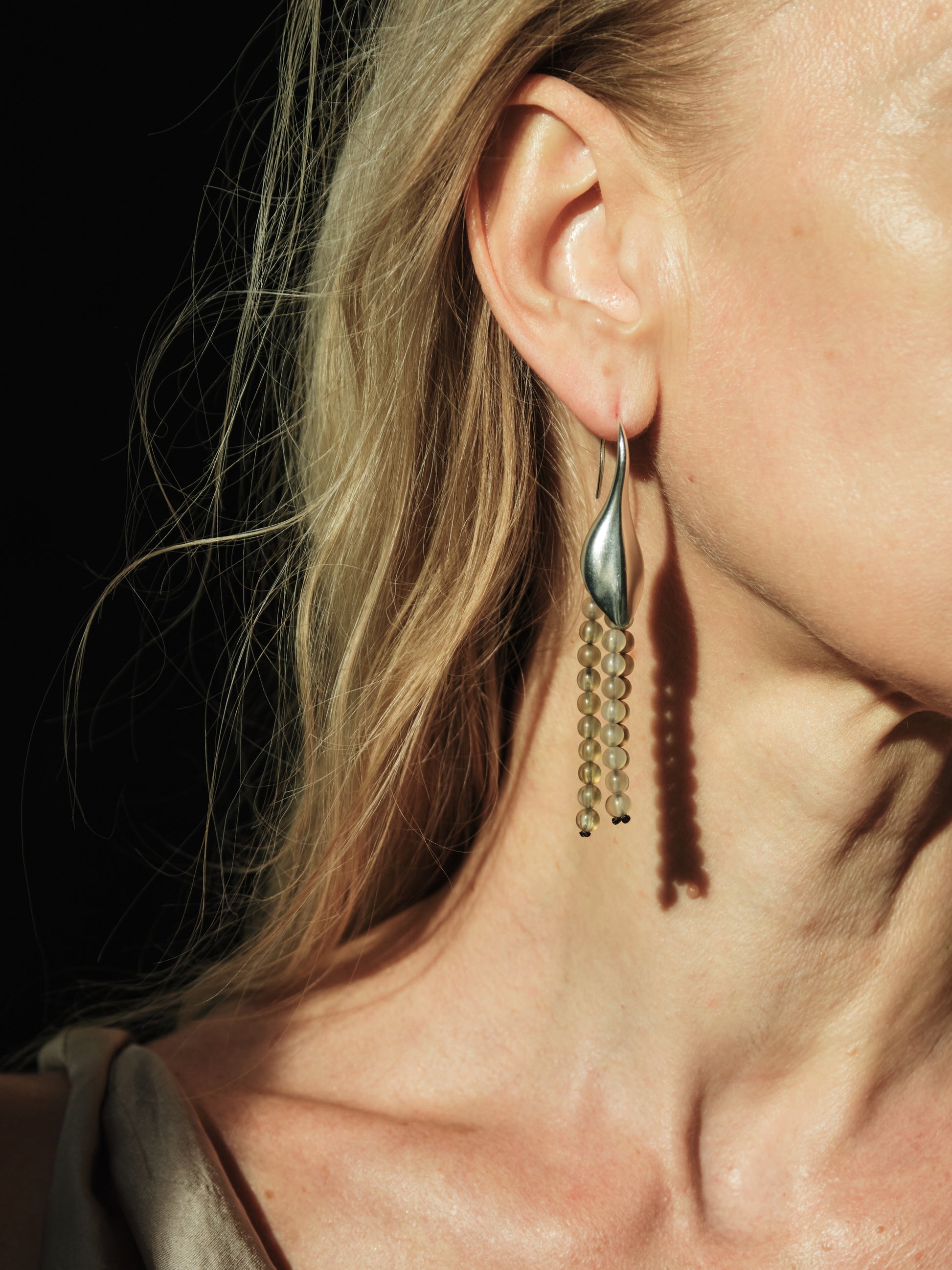 RIVERLAKE petal earrings made from sheep horn, showcasing a unique organic shape and natural texture.