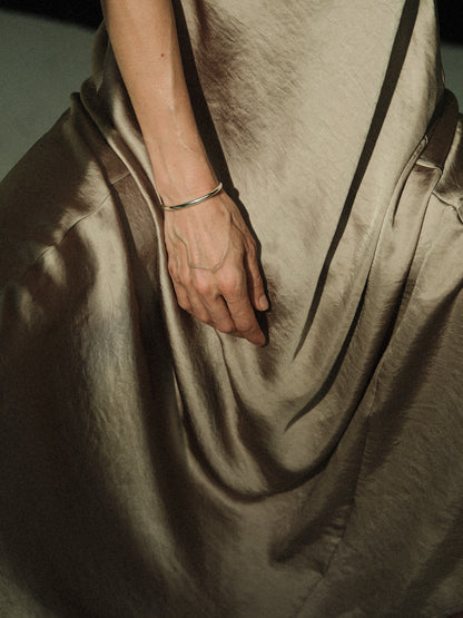 RIVERLAKE Gleam Wrist Cuff featuring a sleek design with a shiny finish and adjustable strap for a comfortable fit.