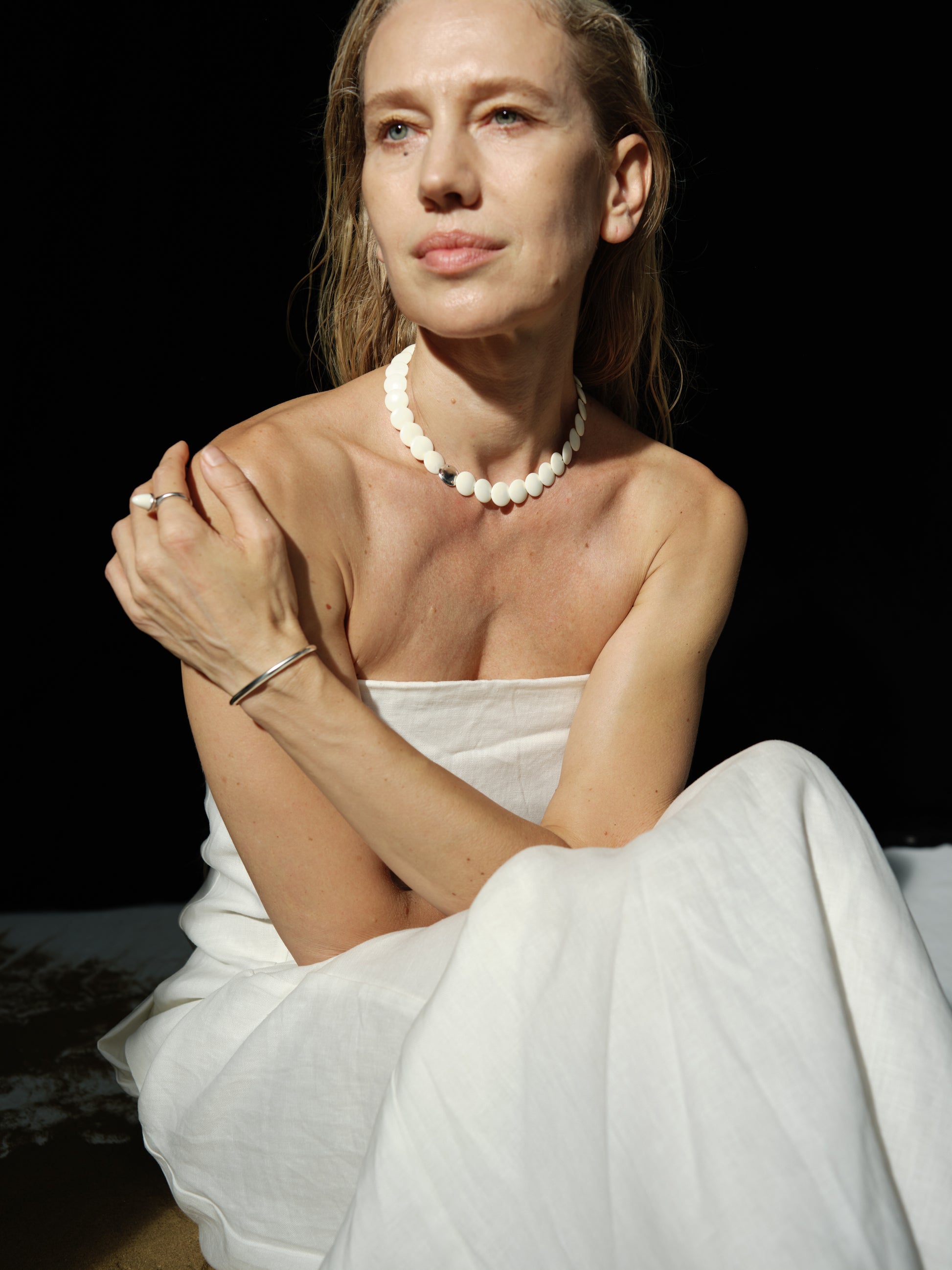 Coco Necklace by RIVERLAKE featuring an antler pendant on a delicate chain against a soft background.