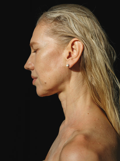 Ox bone teeth studs by RIVERLAKE, showcasing intricate design and natural color variations.