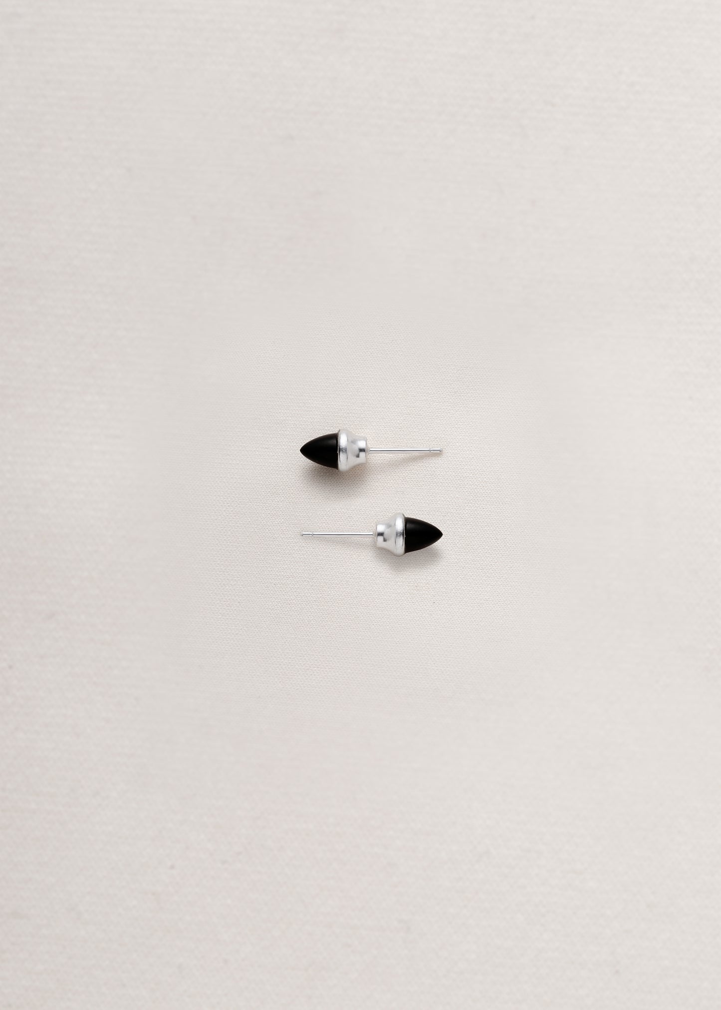 Black buffalo horn teeth studs by RIVERLAKE, featuring a sleek design and natural finish.