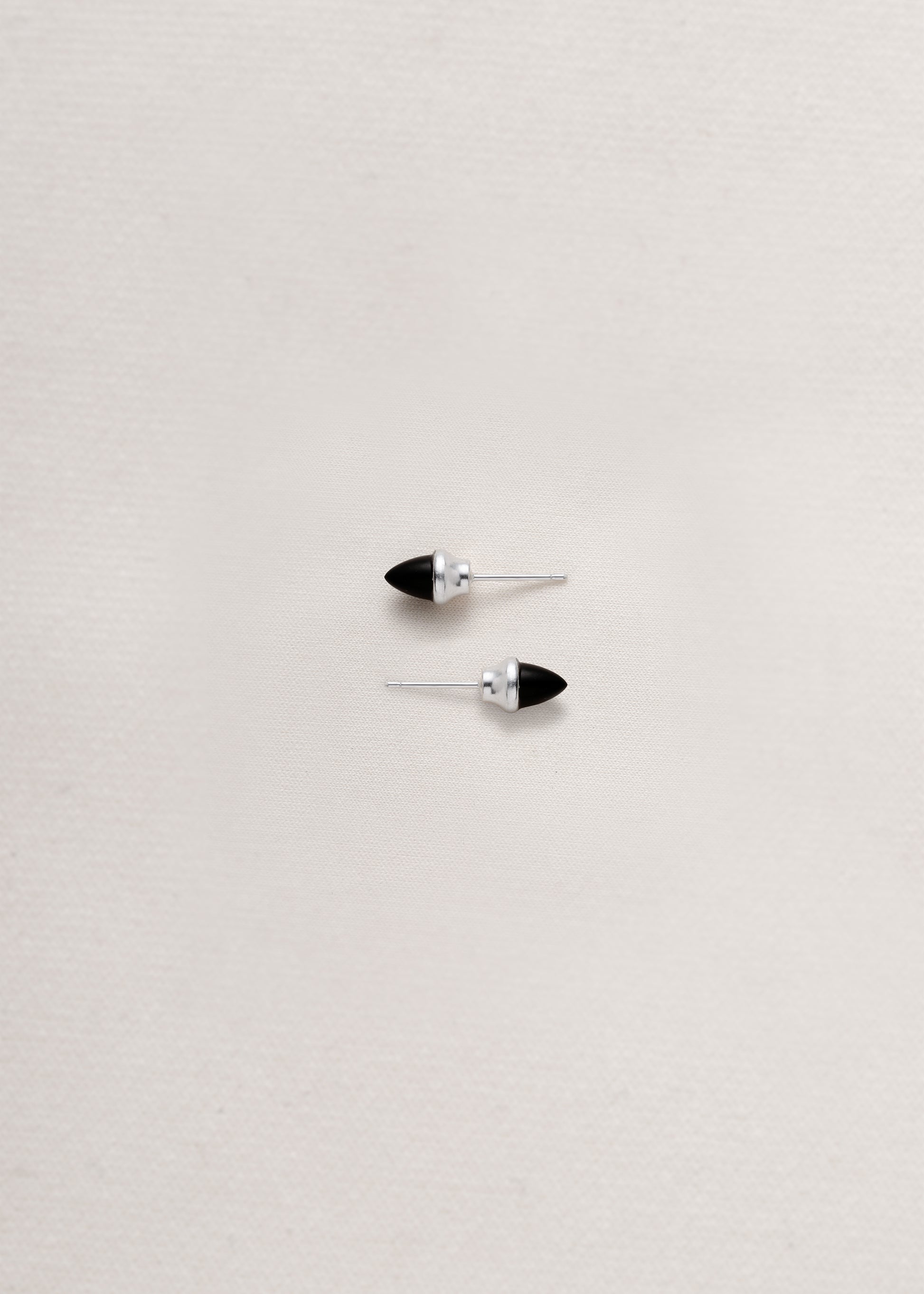 Black buffalo horn teeth studs by RIVERLAKE, featuring a sleek design and natural finish.