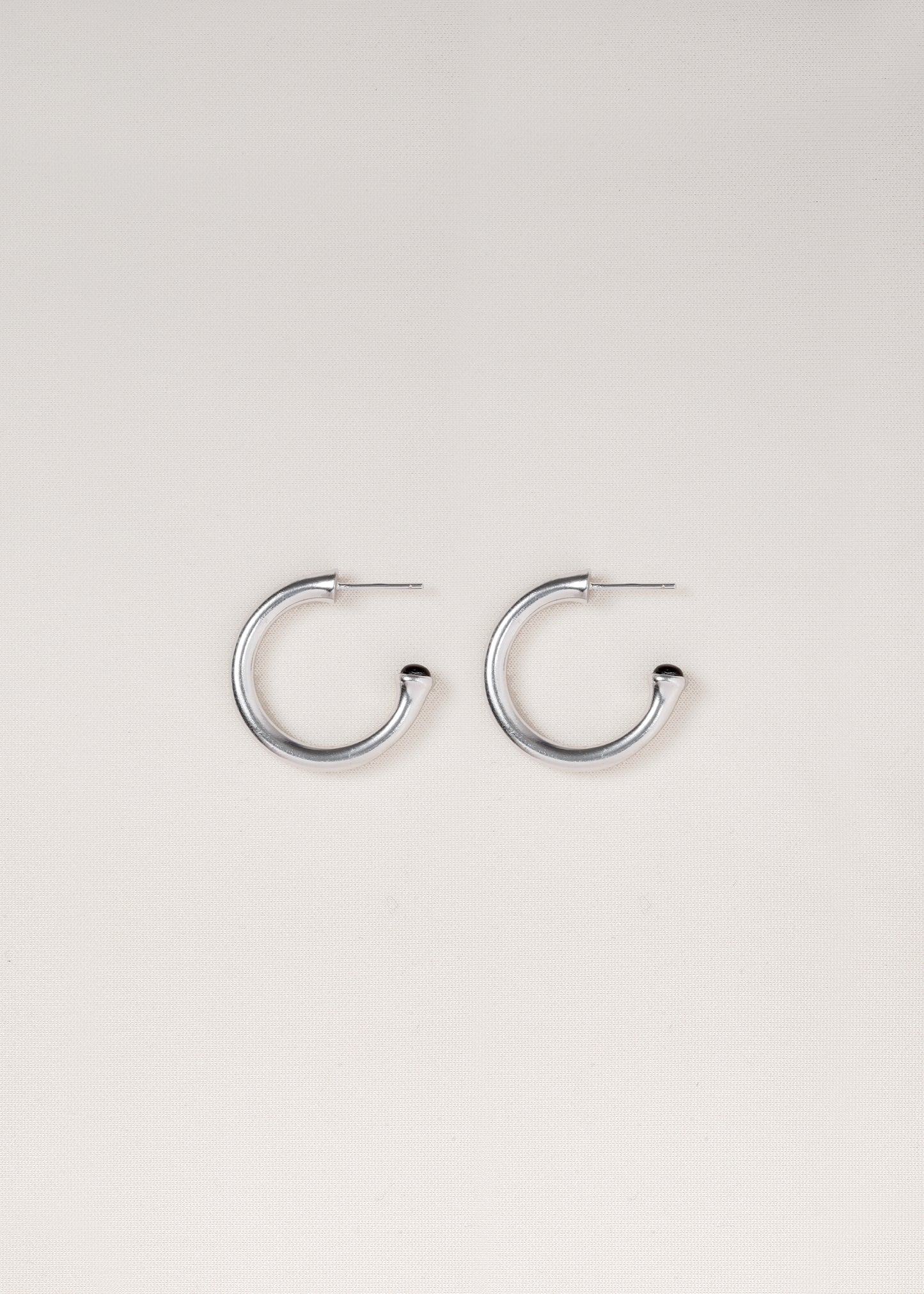 Small black buffalo horn signature hoops by RIVERLAKE, showcasing a sleek and modern design.