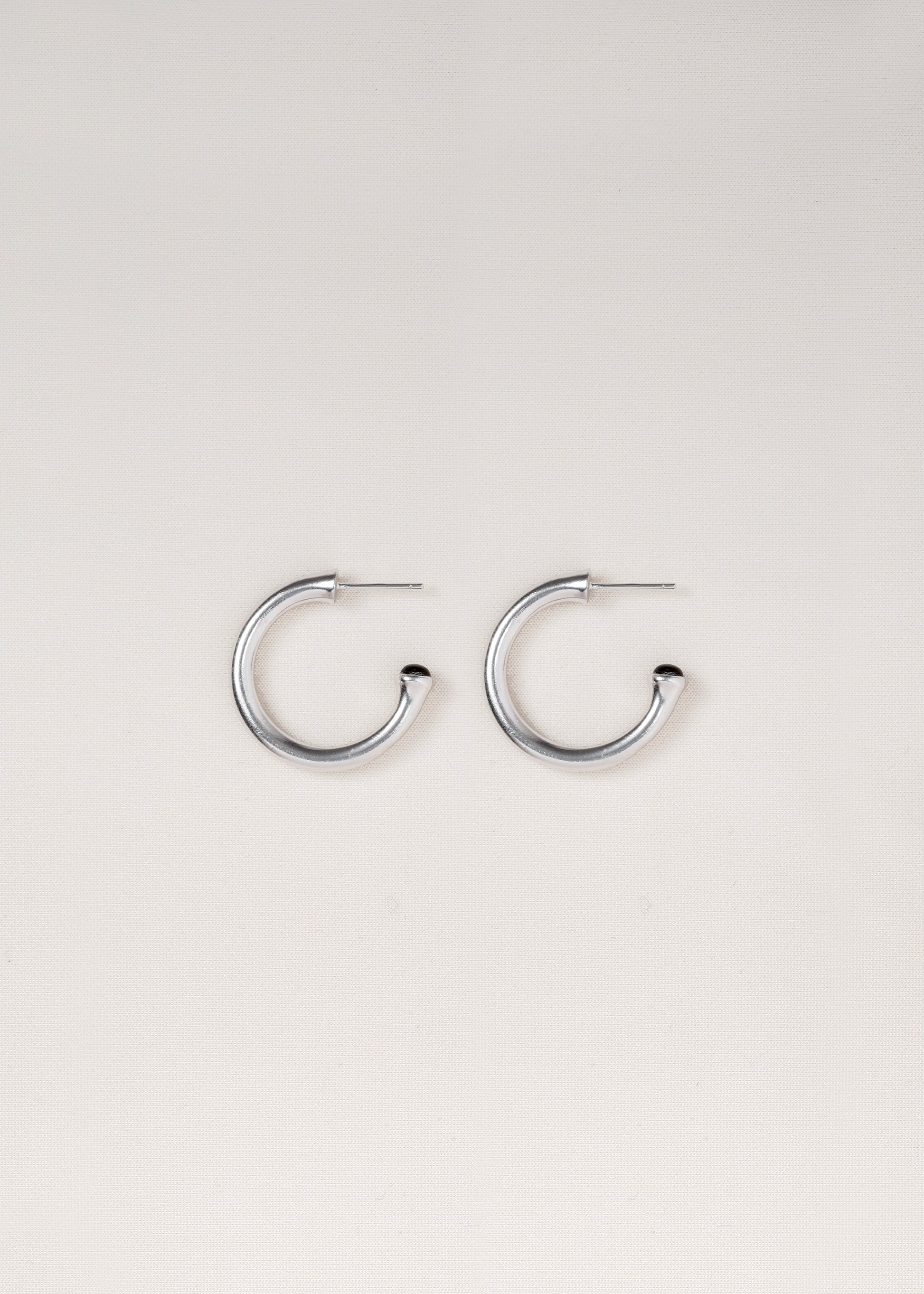 Small black buffalo horn signature hoops by RIVERLAKE, showcasing a sleek and modern design.