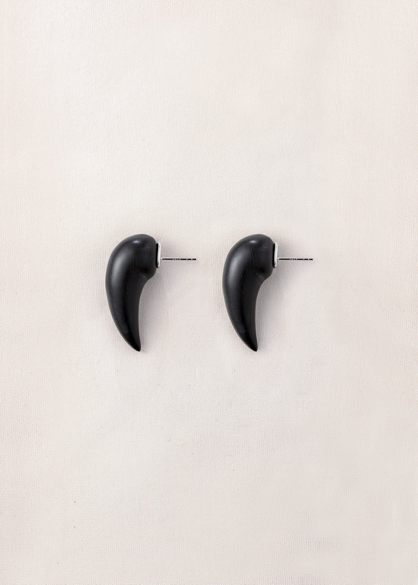 Medium fang earrings made of black buffalo horn by RIVERLAKE, showcasing a sleek, modern design.
