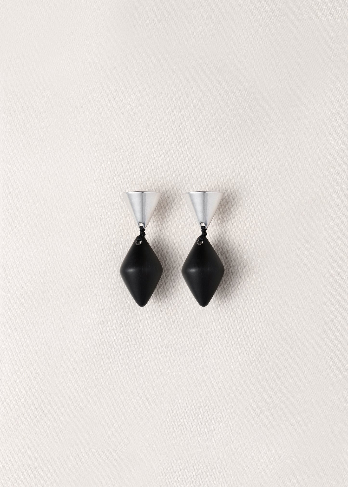 RIVERLAKE black buffalo horn cone drop earrings with a sleek, modern design, showcasing a unique texture and shape.