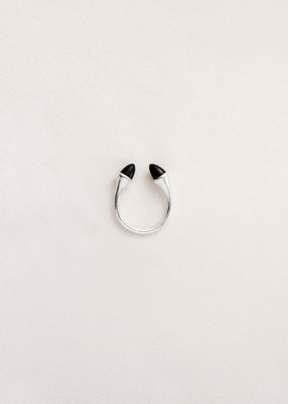 Black buffalo horn teeth ring by RIVERLAKE, showcasing a unique, textured design in a circular shape.