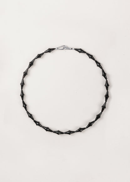 RIVERLAKE Nyx necklace featuring a unique black buffalo horn design, elegantly displayed on a neutral background.