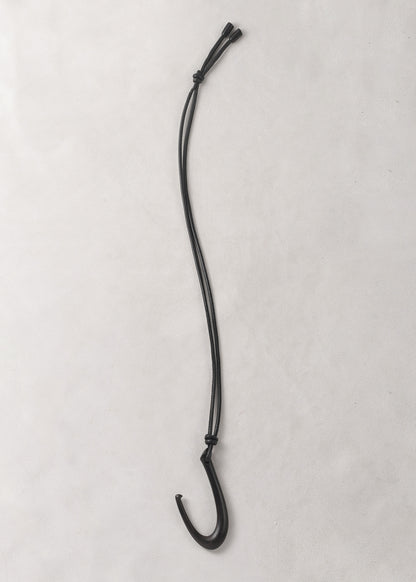 RIVERLAKE Hook Pendant in Ebony with a sleek, modern design and a polished finish hanging on a minimalist display.