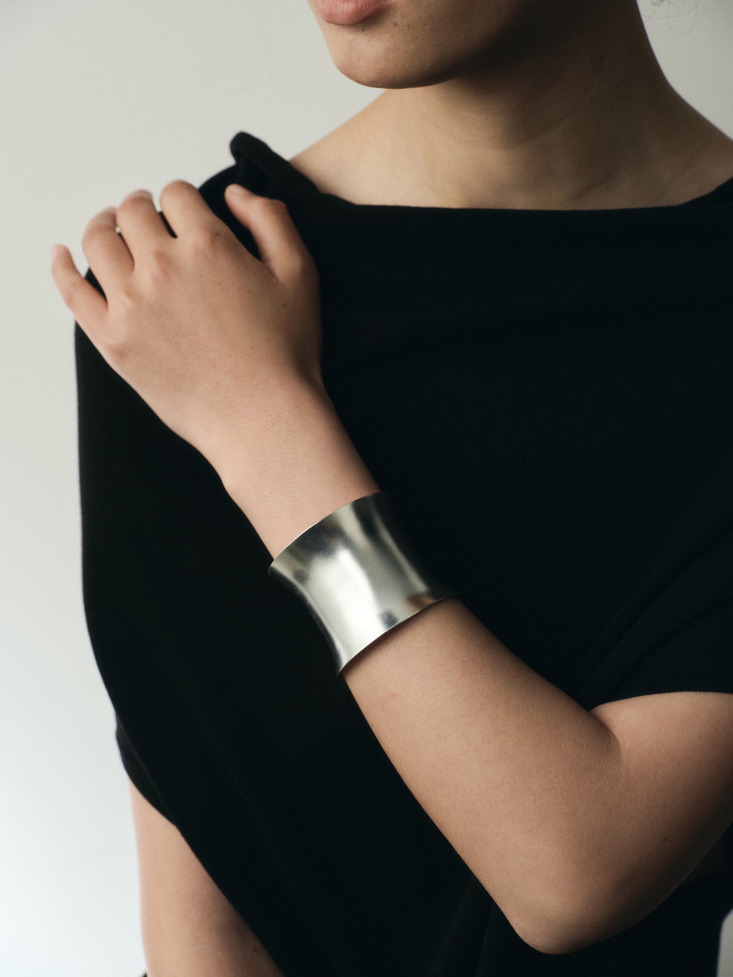 Silver Argent Cuff by RIVERLAKE displayed elegantly on a soft fabric background with subtle texture.