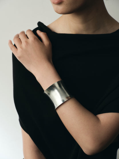 Silver Argent Cuff by RIVERLAKE displayed elegantly on a soft fabric background with subtle texture.