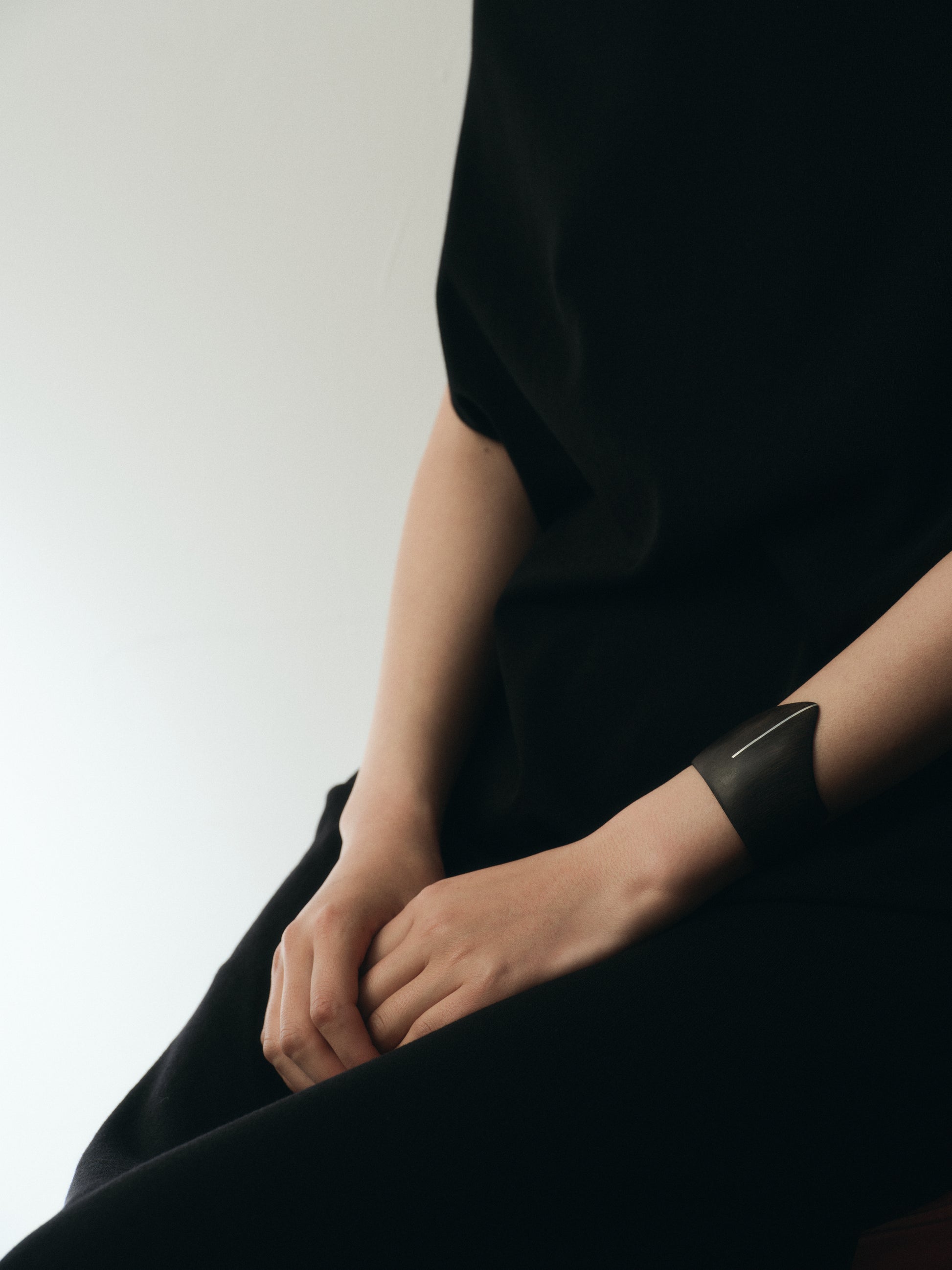 RIVERLAKE Shield Cuff in ebony wood with intricate silver inlay detail, showcasing a stylish and unique design.