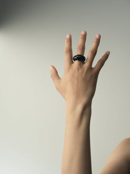 Black buffalo horn curl ring adorned with silver rivets by RIVERLAKE, showcasing a unique and stylish design.