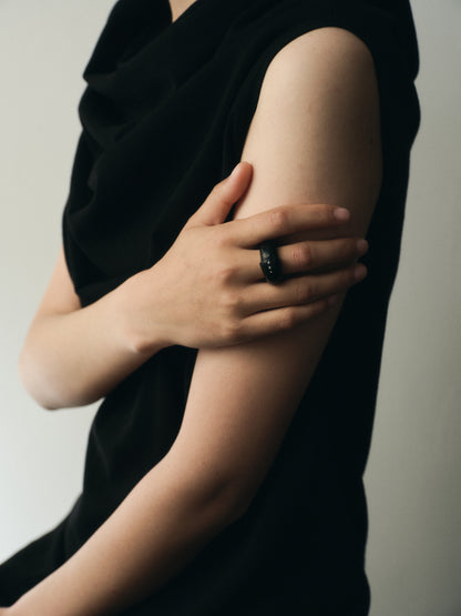 Black buffalo horn curl ring with silver rivets by RIVERLAKE, showcasing an elegant and unique design.