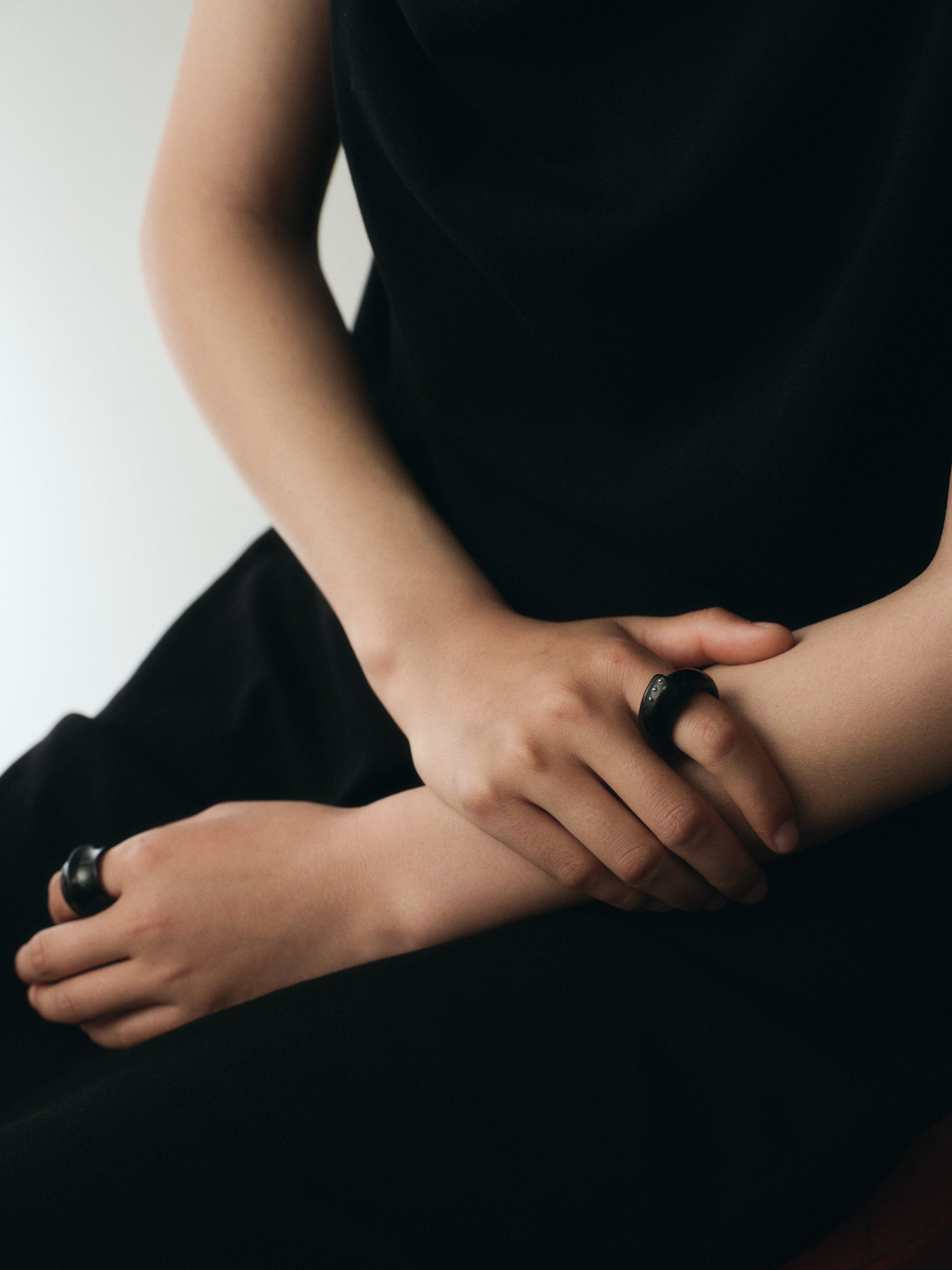 Black buffalo horn curl ring with silver rivets by RIVERLAKE, showcasing a unique and stylish design.