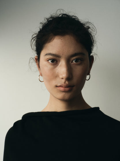 Small yellow buffalo horn hoops by RIVERLAKE, showcasing a unique, lightweight design with a natural finish.