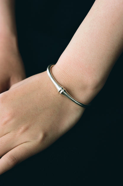 RIVERLAKE Talon Cuff made of black buffalo horn showcasing its unique texture and elegant design.