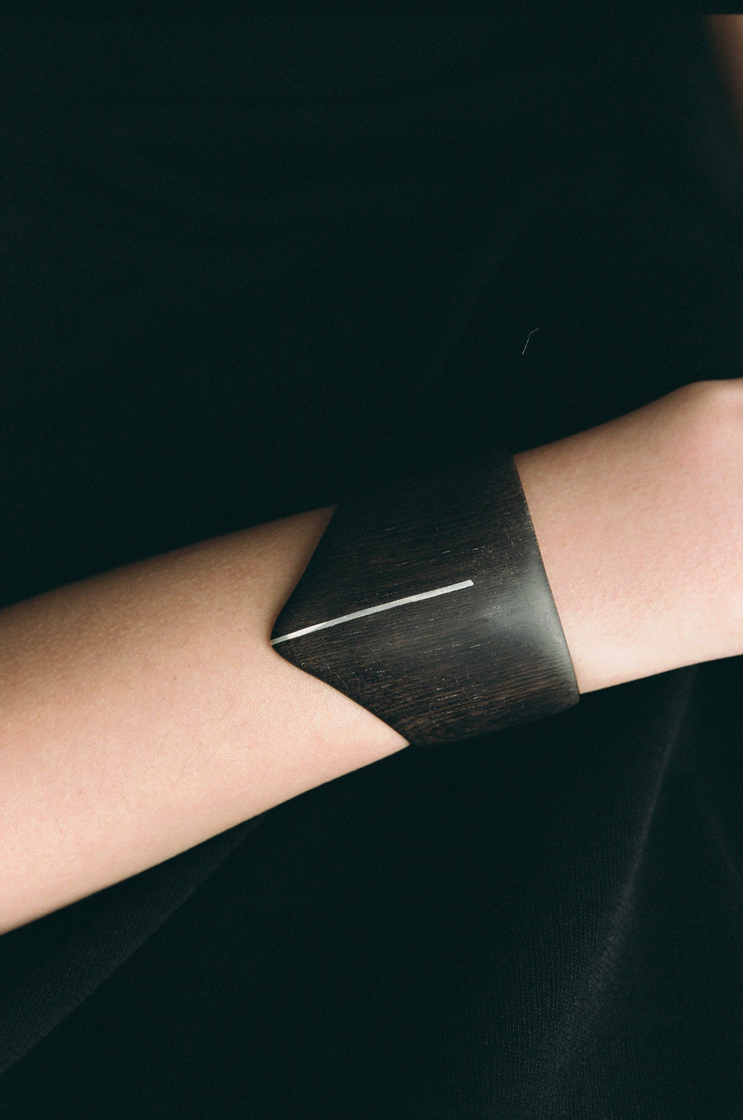 RIVERLAKE Shield Cuff in ebony wood featuring a sleek silver inlay design.