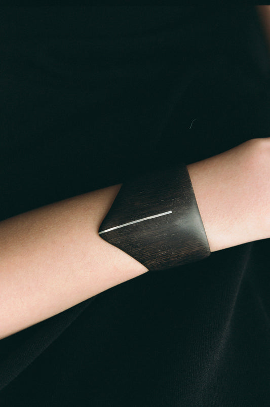 RIVERLAKE Shield Cuff in ebony wood featuring a sleek silver inlay design.