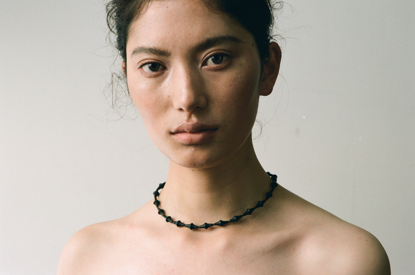 RIVERLAKE Nyx Necklace featuring a striking black buffalo horn pendant on a delicate chain.