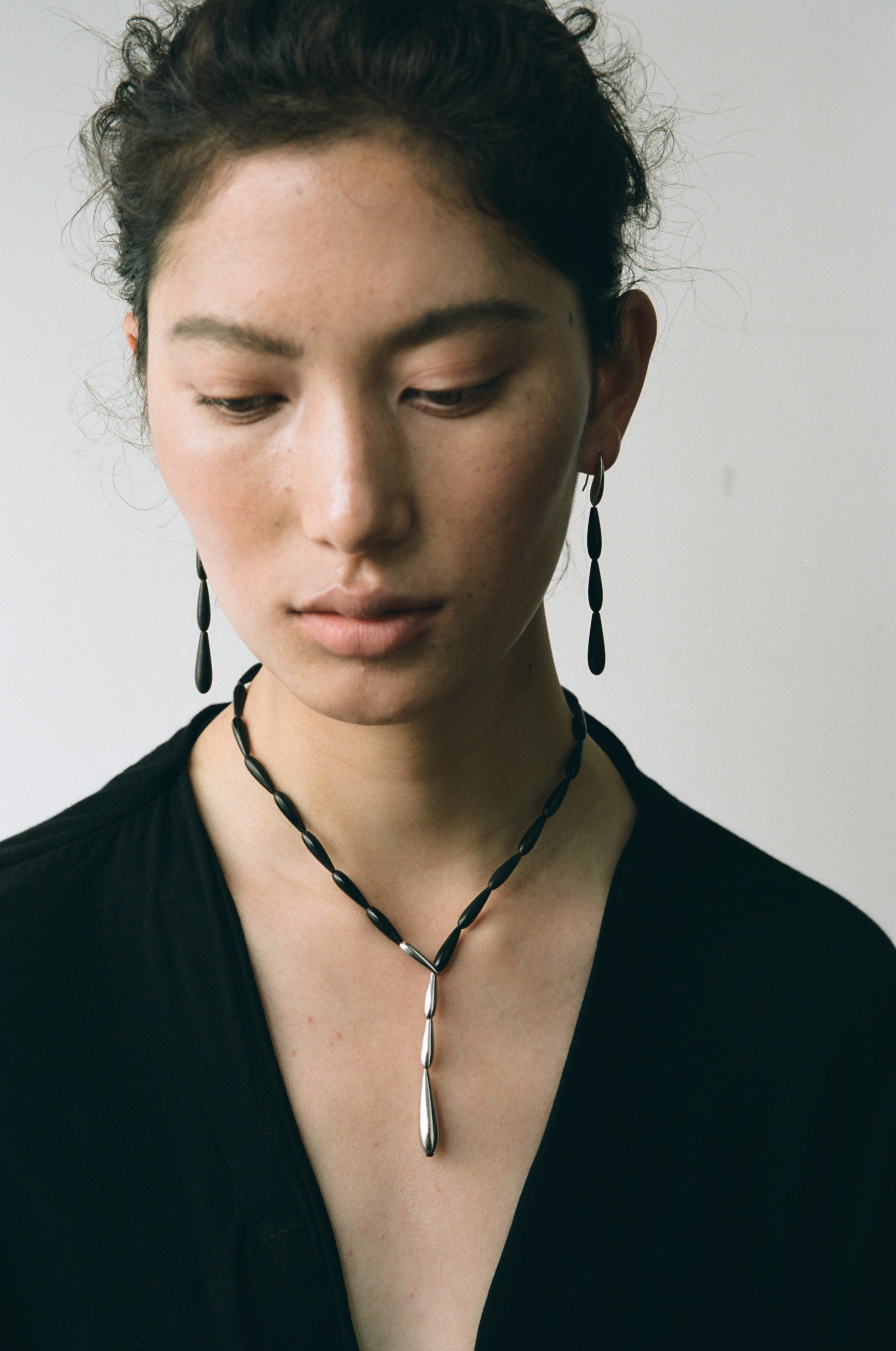 Long spring earrings made of black buffalo horn by RIVERLAKE, featuring a sleek and elegant design.