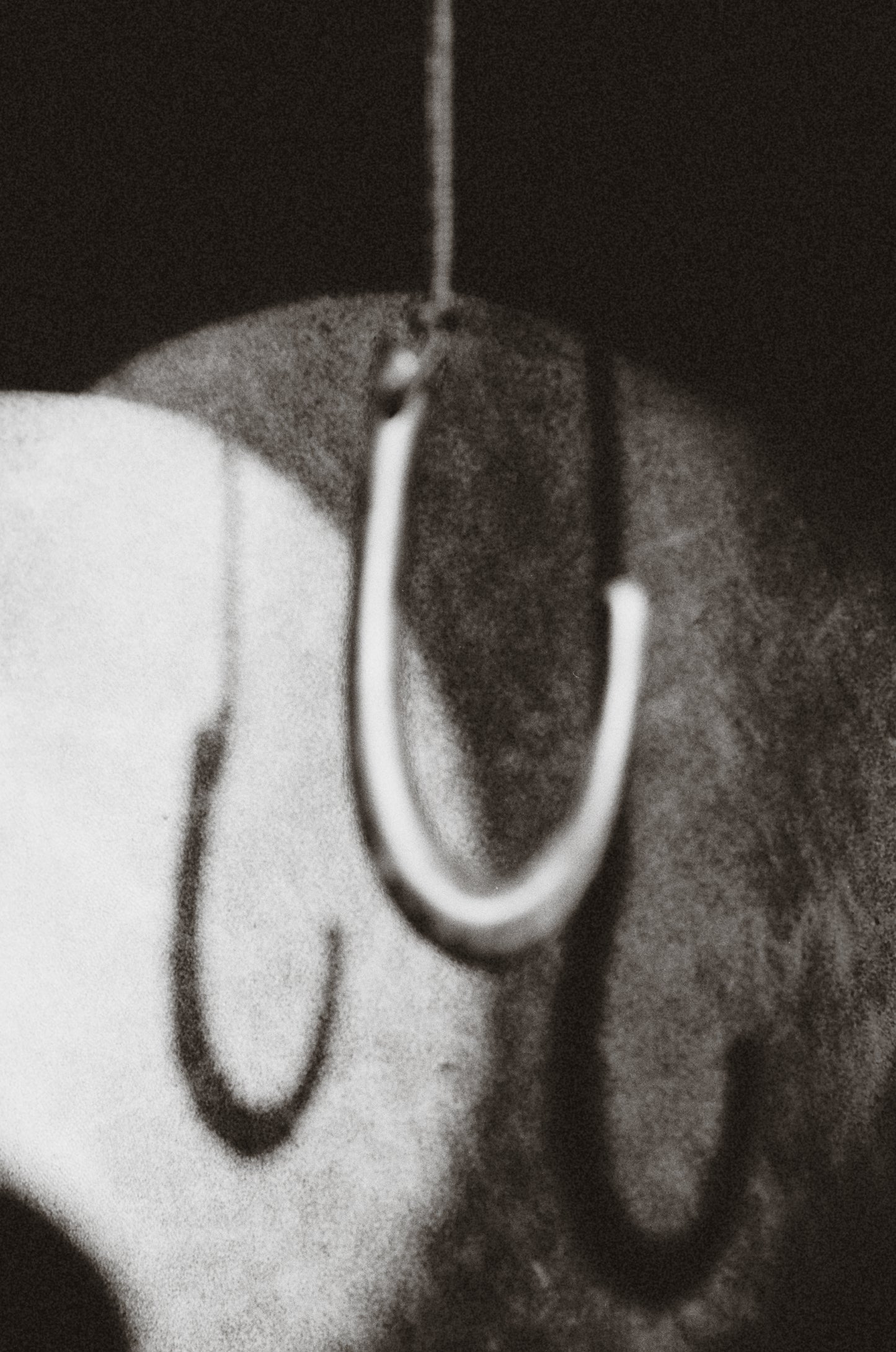 RIVERLAKE Hook Pendant in Ebony, featuring a sleek design and rich dark finish, elegantly displayed on a neutral background.