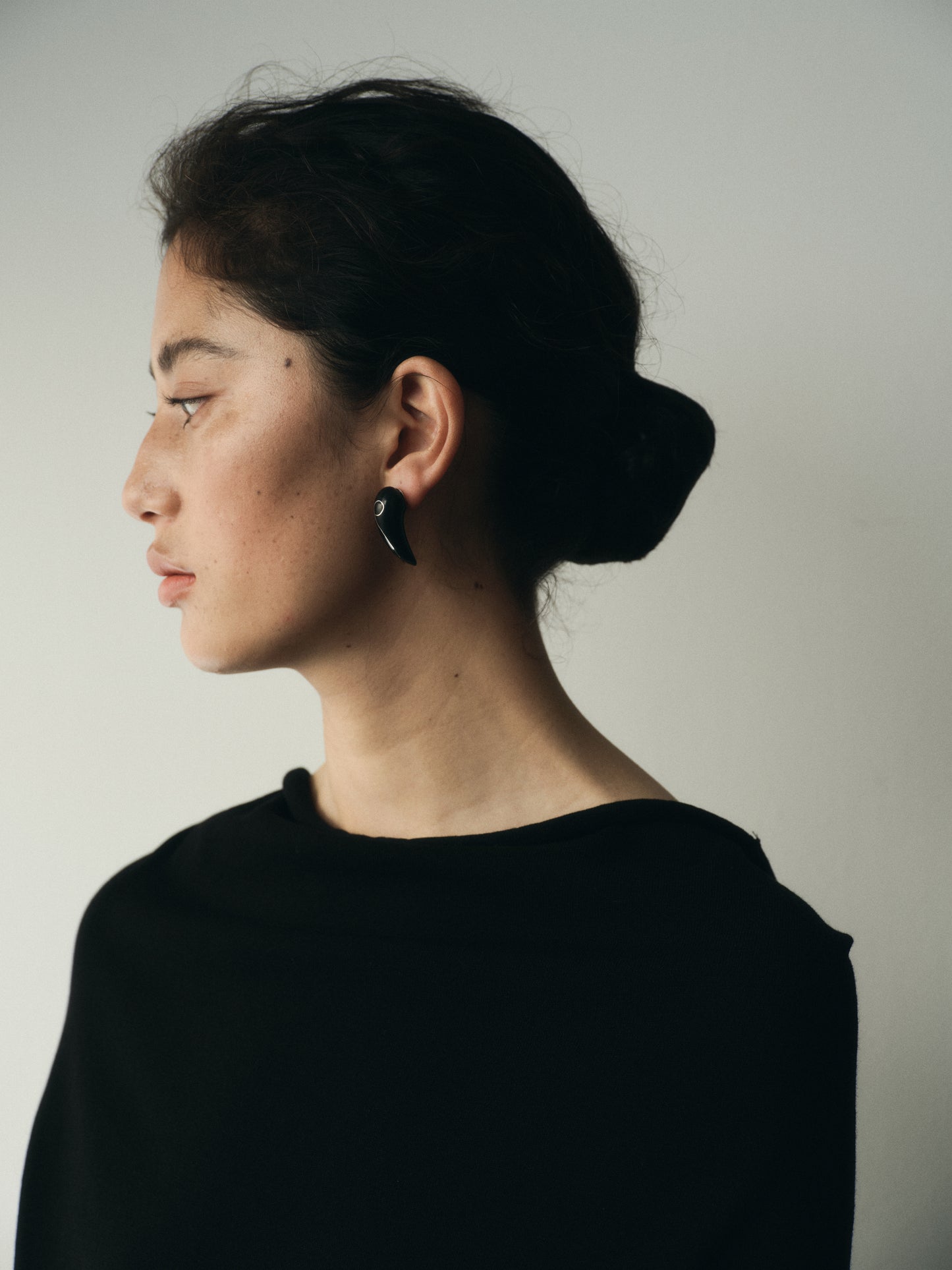 Medium Fang Earrings by RIVERLAKE, crafted from black buffalo horn with intricate silver inlay design.