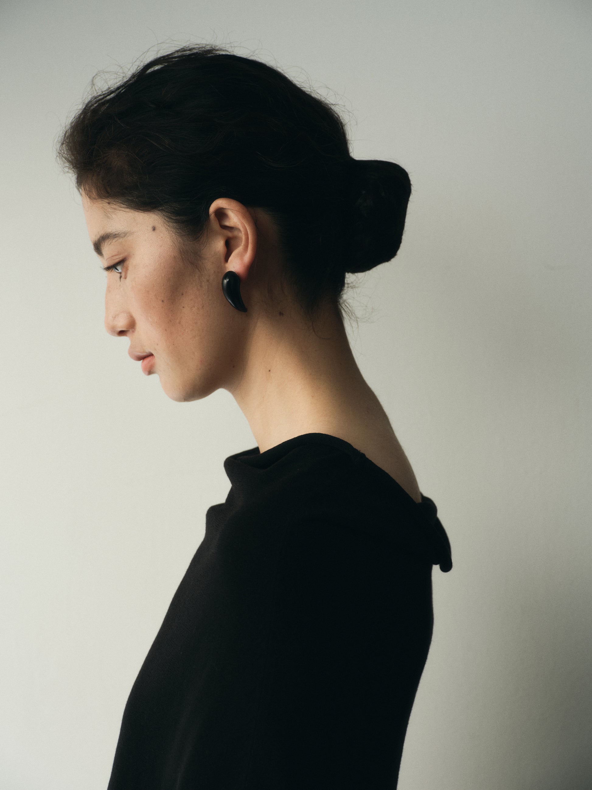 Medium Fang Earrings by RIVERLAKE crafted from black buffalo horn, showcasing a unique, bold design.