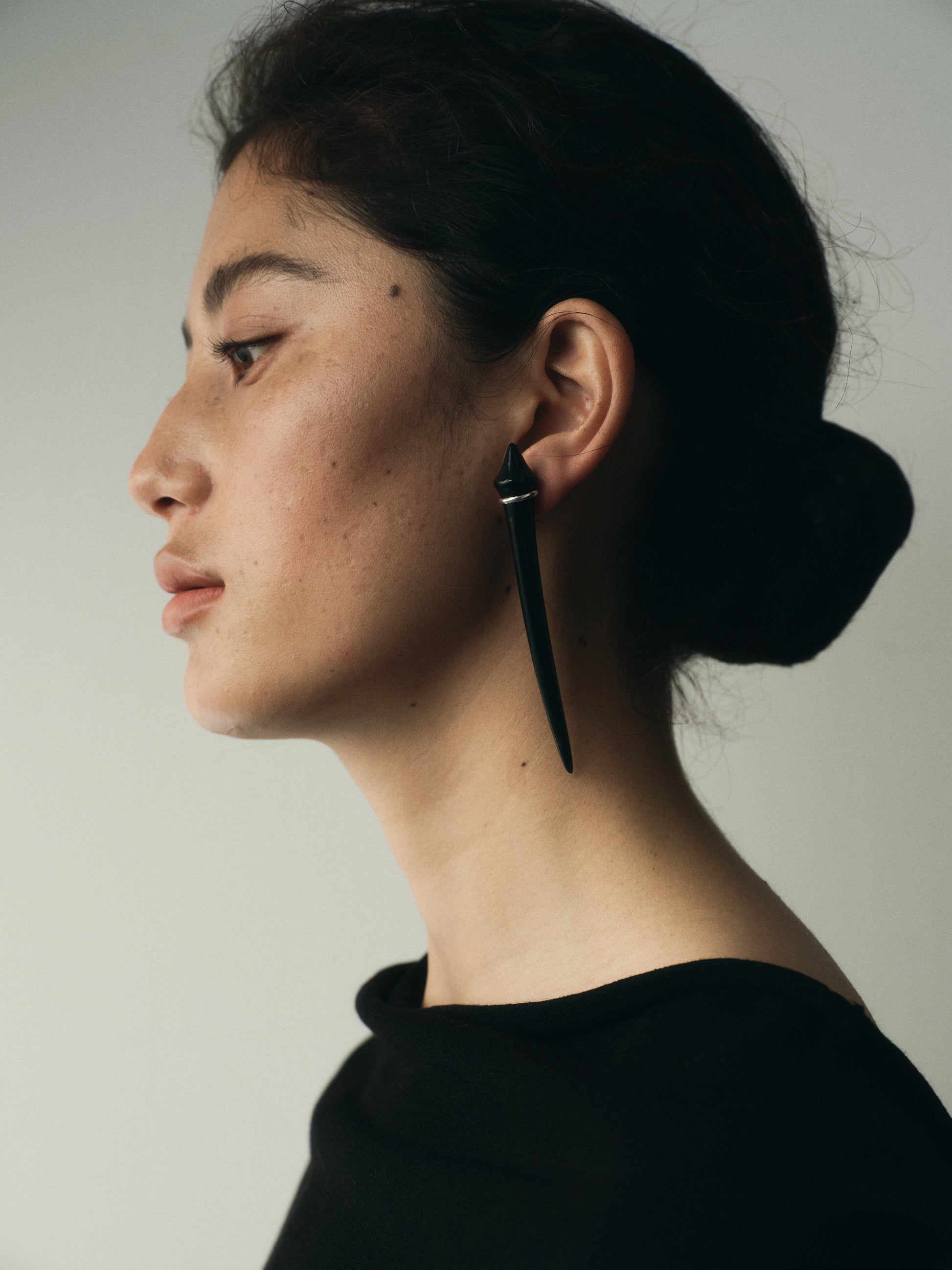 Long tooth earrings made of black buffalo horn by RIVERLAKE, featuring a sleek and elegant design.